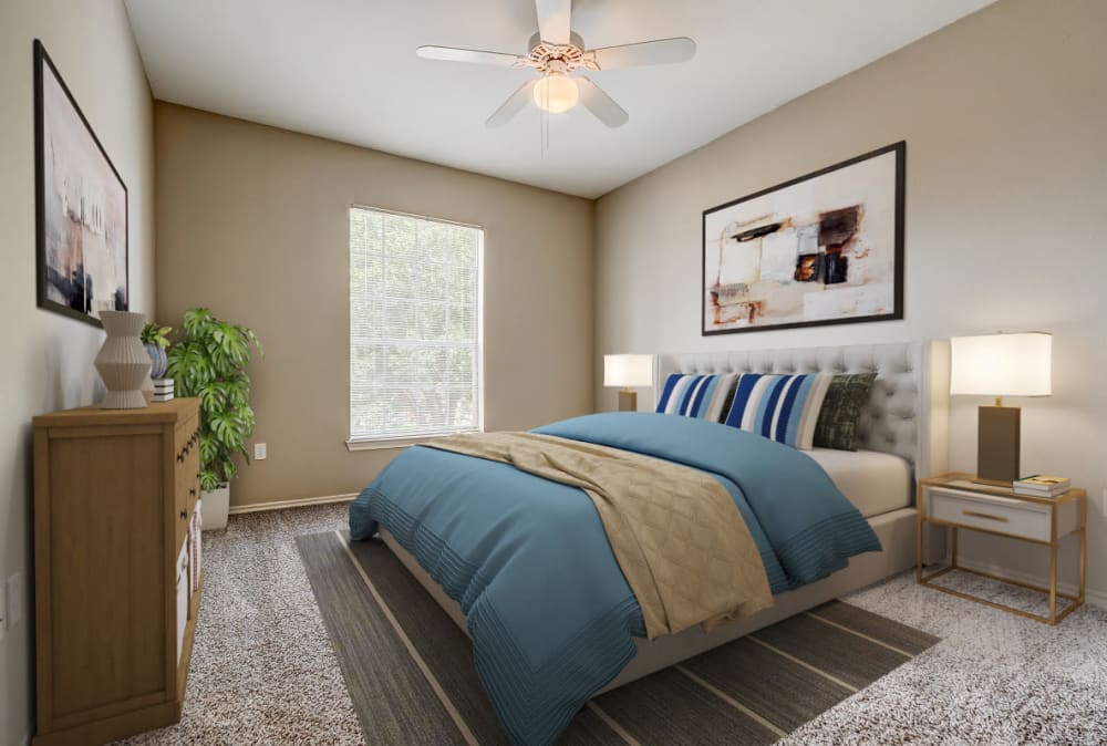Bedroom with large window at Champion Lake Apartment Homes in Shreveport, Louisiana