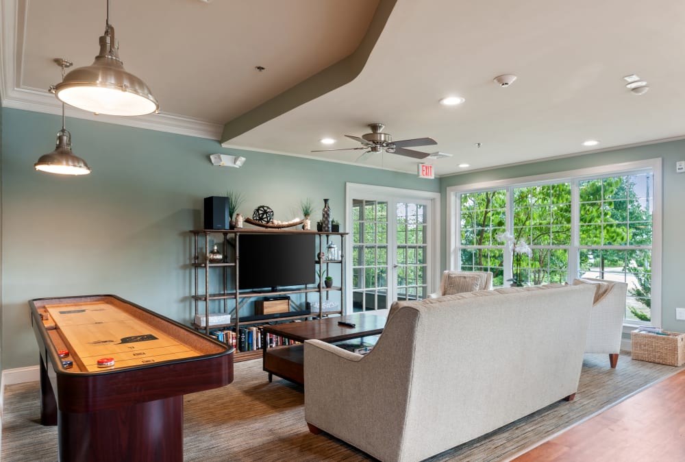 Media center and shuffleboard table at Strafford Station Apartments in Wayne, Pennsylvania