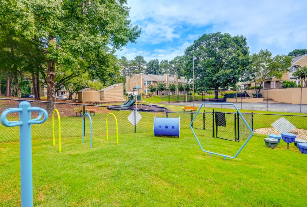 Fenced in dog park at Grove at Stonebrook Apartments & Townhomes in Norcross, Georgia