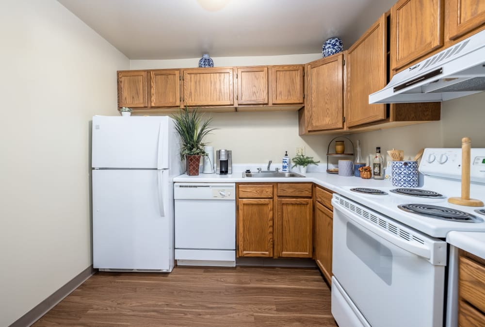 Beautiful modern kitchen with white appliances at Maiden Bridge & Canongate Apartments in Pittsburgh, Pennsylvania