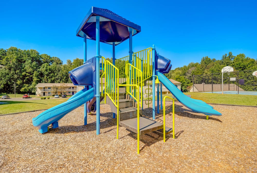 Apartments with a Playground equipped with a slide located at Huntersville Apartment Homes in Huntersville, North Carolina