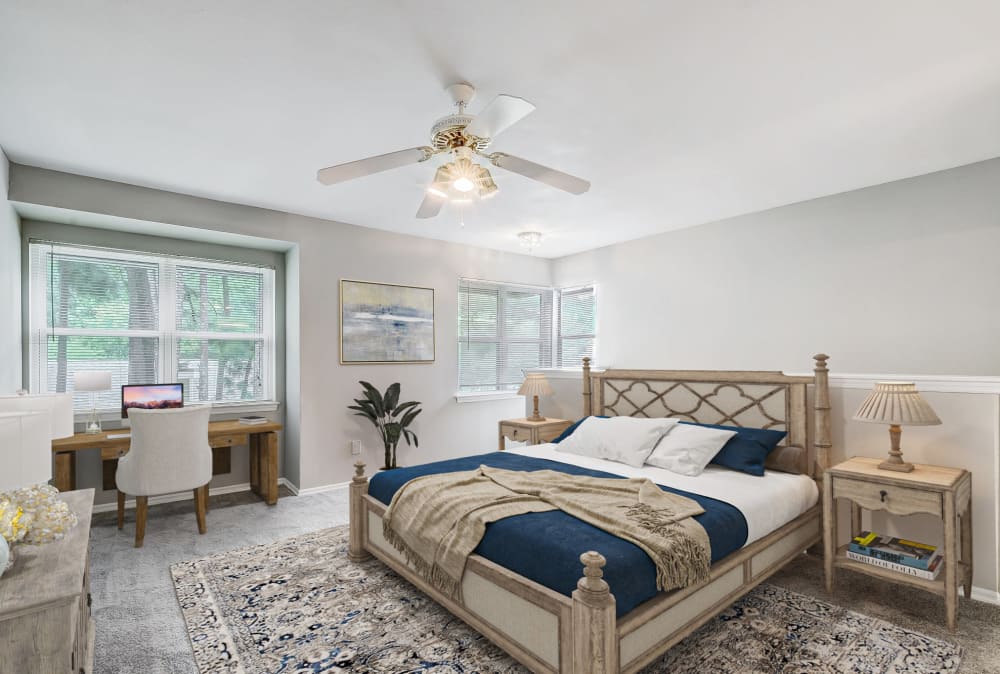 Spacious bedroom with a ceiling fan at Grove at Stonebrook Apartments & Townhomes in Norcross, Georgia