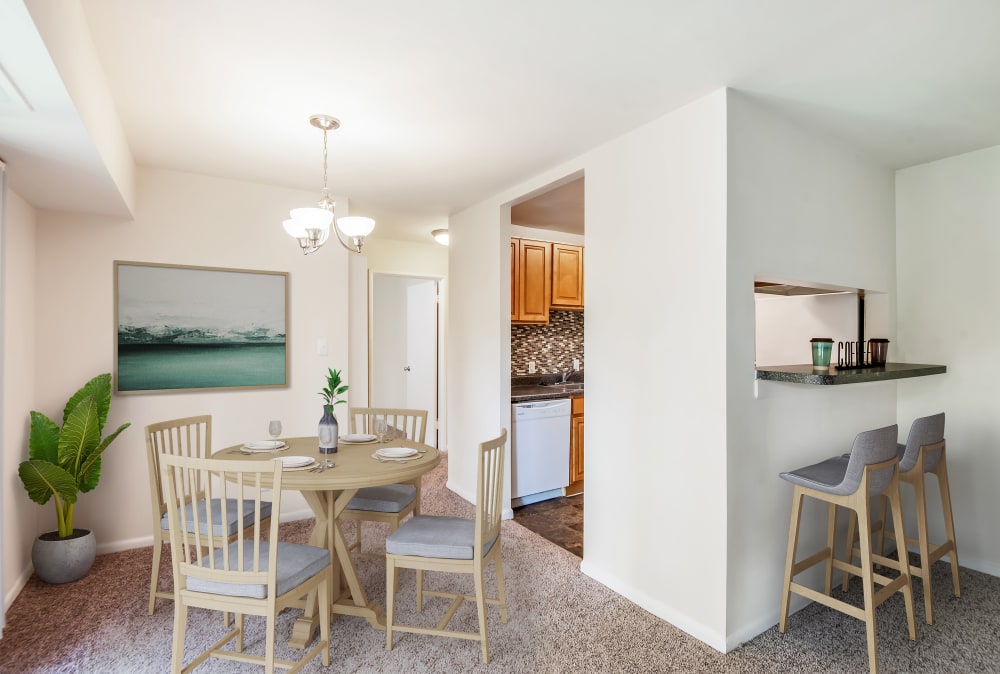 Staged dining area and breakfast bar at Harbor Place Apartment Homes in Fort Washington, Maryland