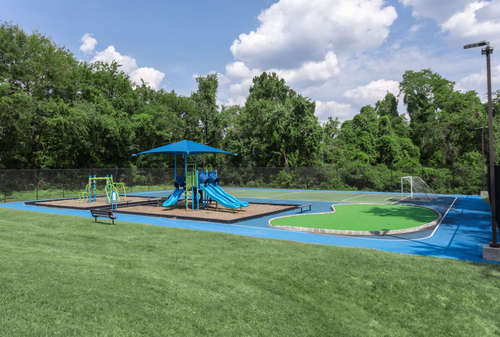 Apartments with a Playground equipped with a slide located at Jackson Grove Apartment Homes in Hermitage, Tennessee
