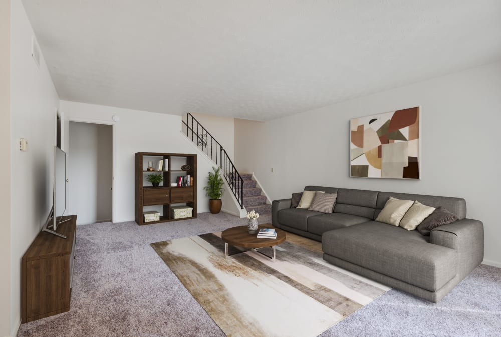 Living room with wall to wall carpeting at Brighton Colony Townhomes in Rochester, New York