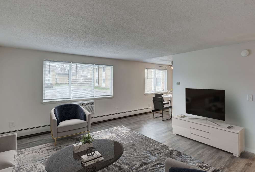 Bright colorful living room with window air conditioner and a television at Ridgeview Apartment Homes in Reading, Pennsylvania