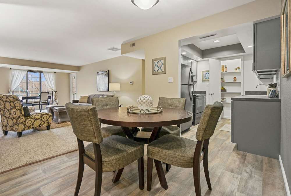 Dining area in a home with wood-style flooring at Canterbury Green in Fort Wayne, Indiana