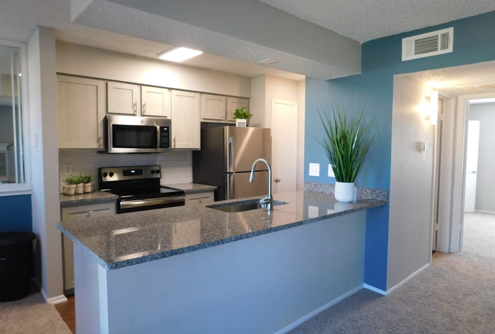 Open-concept floor plan with hardwood floors at Royal Palms in San Antonio, Texas