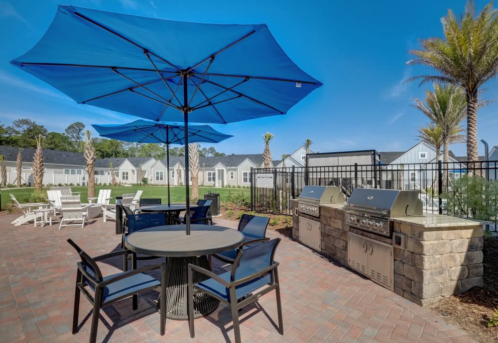 Outdoor covered table and grill stations at Cottage Street at eTown in Jacksonville, Florida