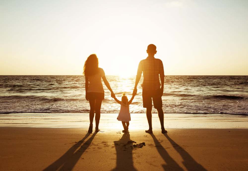 Resident family admiring the sunset on the beach near Cottage Street at eTown in Jacksonville, Florida