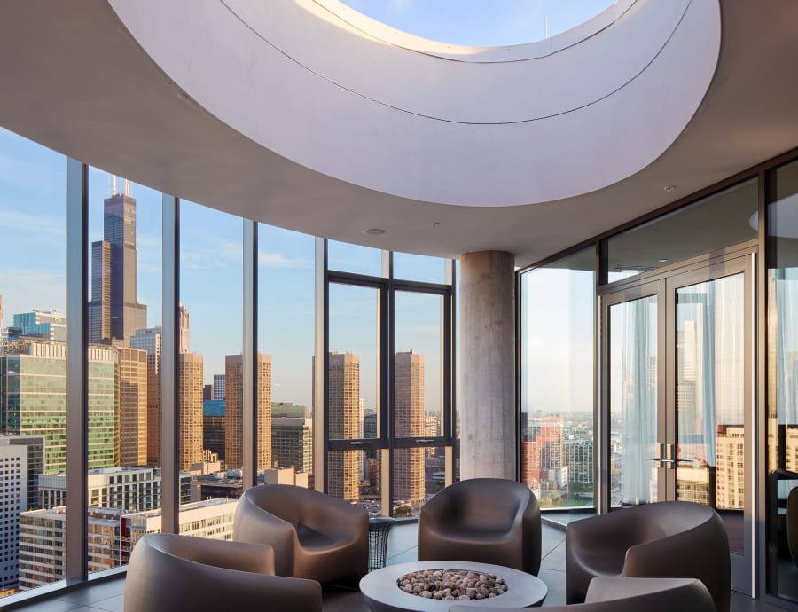 Modern and sleek resident lounge with a great view from the large windows at The Parker Fulton Market in Chicago, Illinois