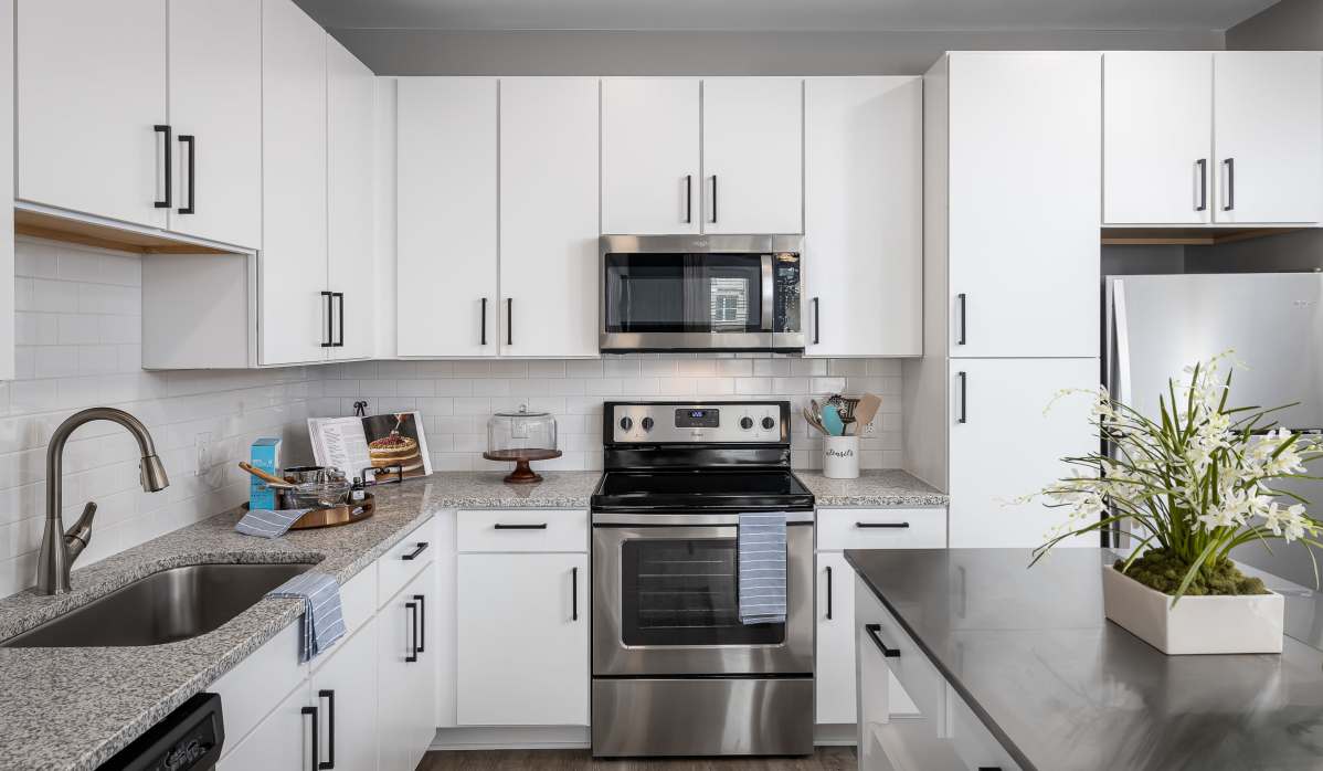Kitchen with appliances and stainless sink at The Kingson in Fredericksburg, Virginia