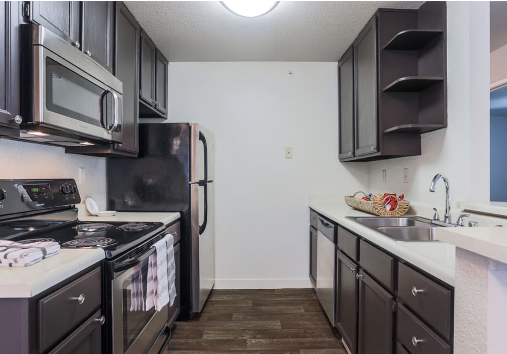 Well-furnished kitchen with wooden cabinets at La Vina Apartments in Livermore, California