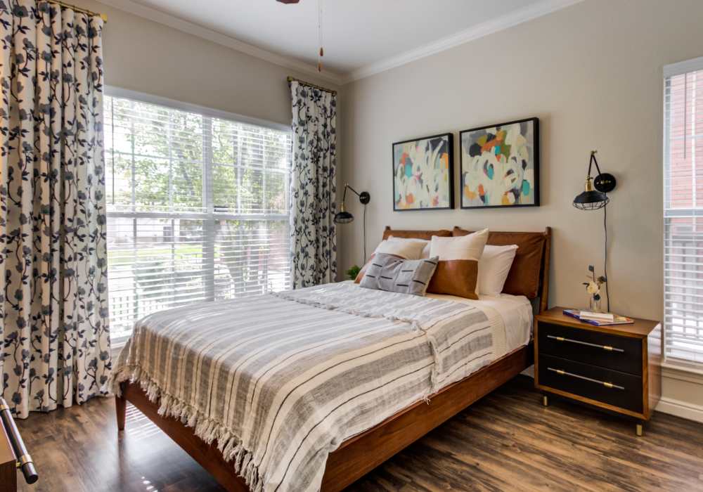 Bright bedroom with large windows at Irving Schoolhouse Apartments in Salt Lake City, Utah,