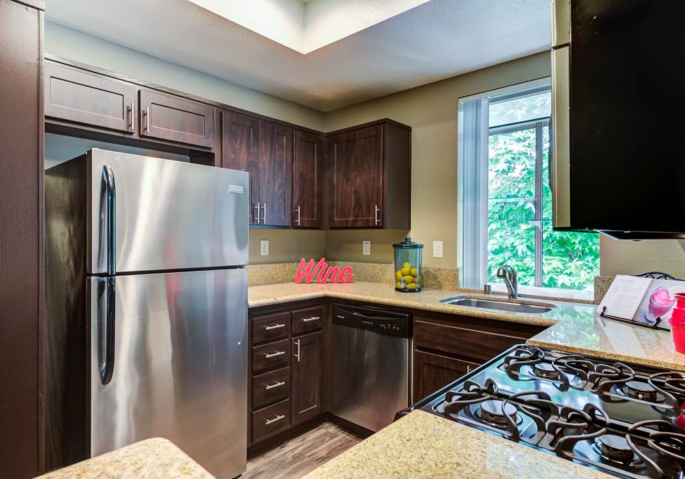 Modern kitchen with wooden cabinets at Seapointe Villas in Costa Mesa, California