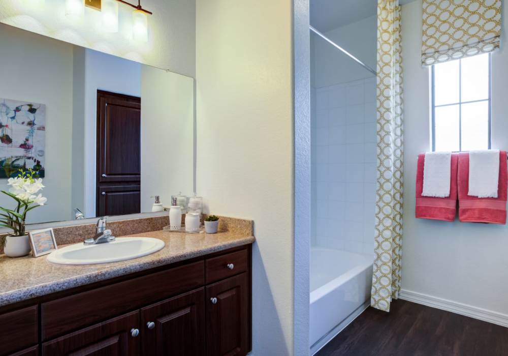 Bright bathroom with large mirror and endant lights at San Marquis in Tempe, Arizona, 