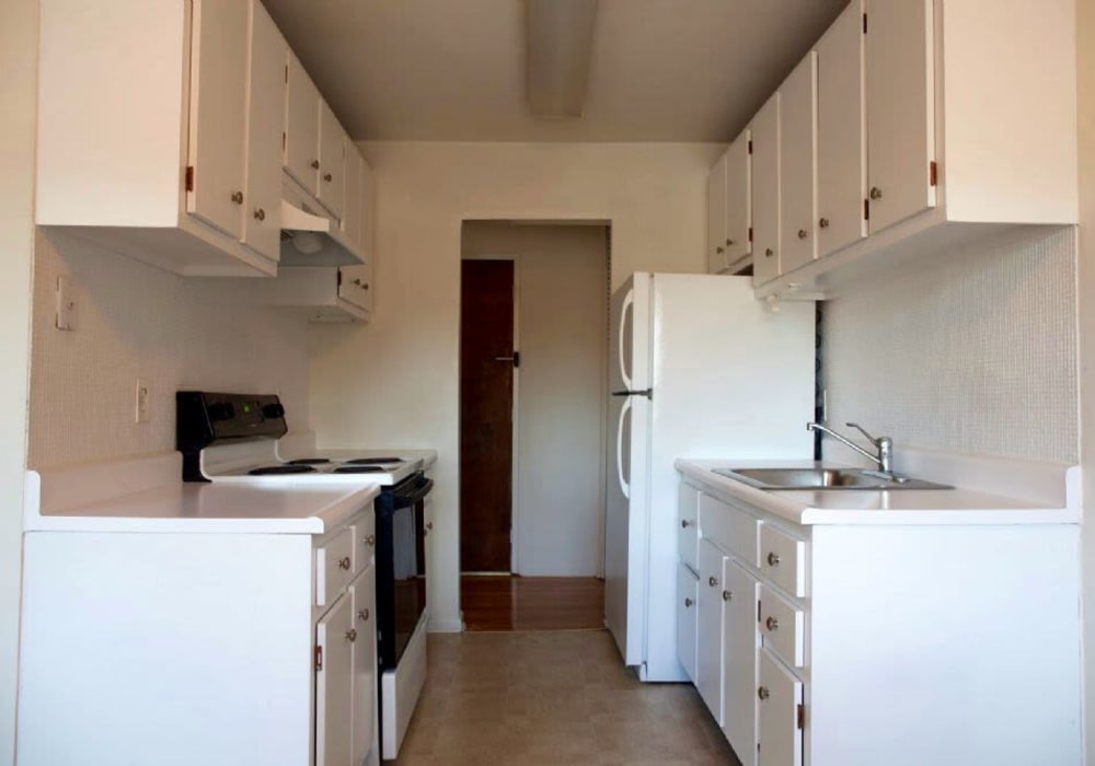 Kitchen with tile style flooring at Versailles Apartments in Ewing, New Jersey