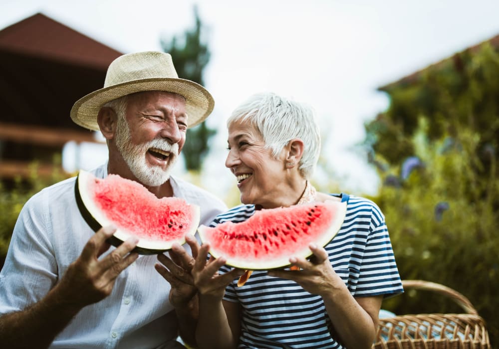 A couple eating watermelon at Little Creek Apartments in Laurel, Delaware