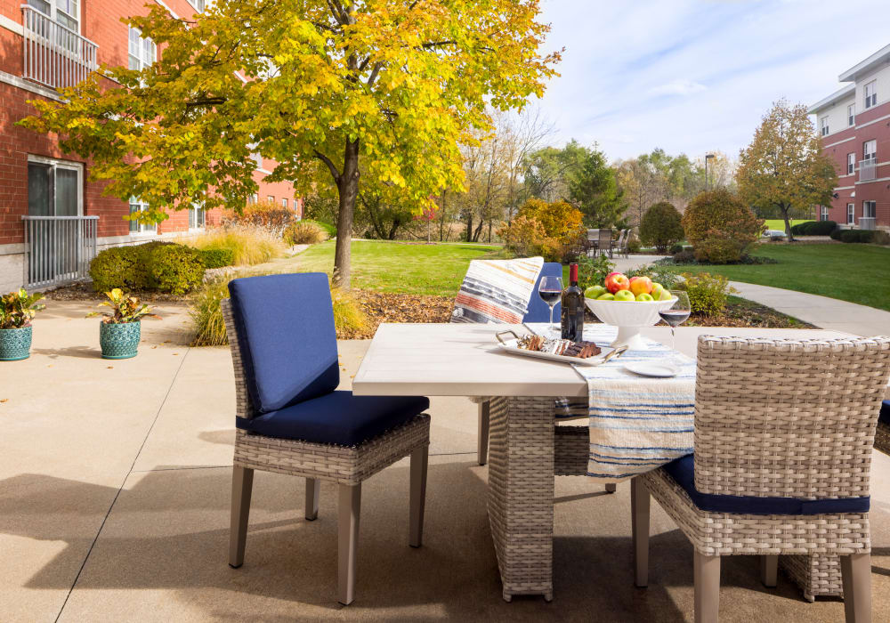 Paved walkway with table and chairs outside at Hanover Place in Tinley Park, Illinois