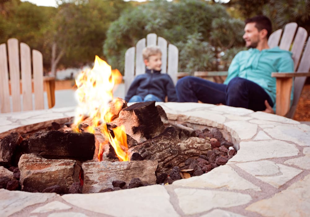 Dad and son sitting by the firepit at Antigua at Lakewood Ranch in Lakewood Ranch, Florida