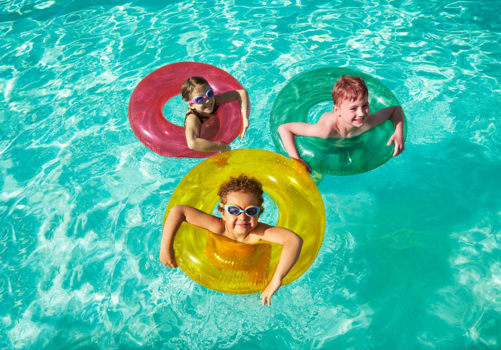 Kids playing on their inner tubes in the pool at BB Living Lakewood Ranch in Lakewood Ranch, Florida