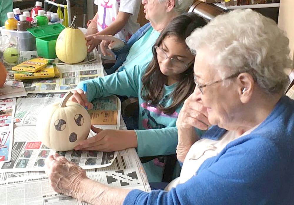 Residents participating in pumpkin crafts at Wellington Place at Hartford in Hartford, Wisconsin