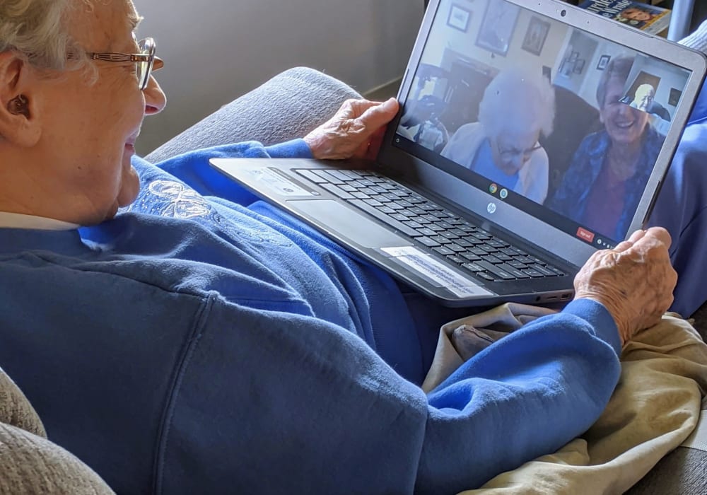 Resident using Skype on a computer at Wellington Place at Hartford in Hartford, Wisconsin