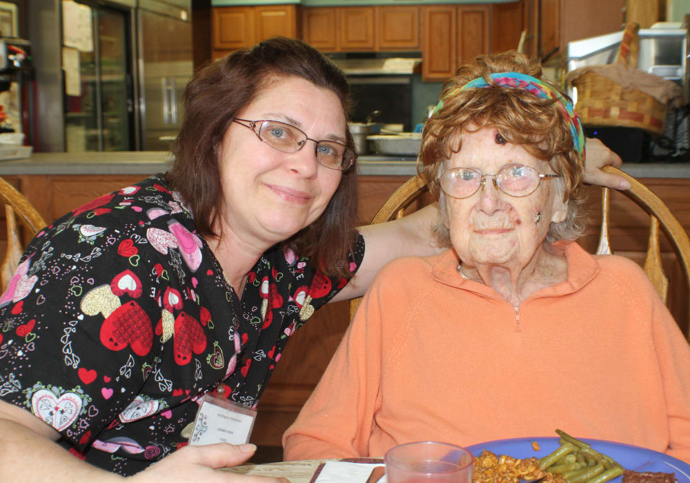Staff member and a resident smiling for a photo at Wellington Meadows in Fort Atkinson, Wisconsin