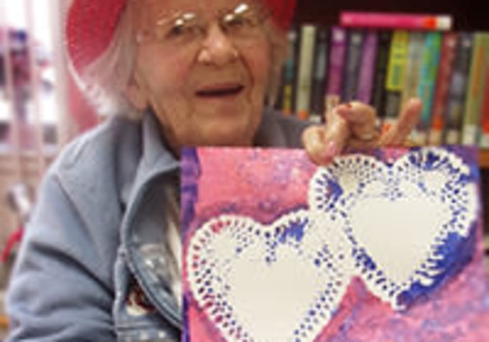 Resident presenting a valentines day card at Ingleside Communities in Mount Horeb, Wisconsin