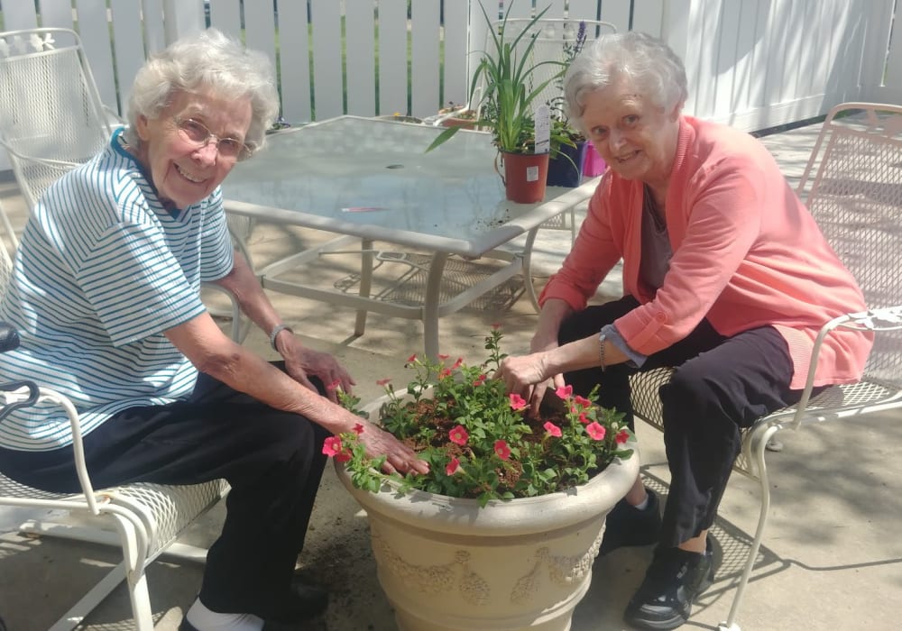 Two residents planting flowers outside at Ingleside Communities in Mount Horeb, Wisconsin
