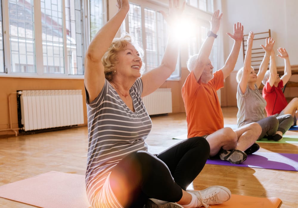 Residents at a community yoga class at Village on the Park Bentonville in Bentonville, Arkansas