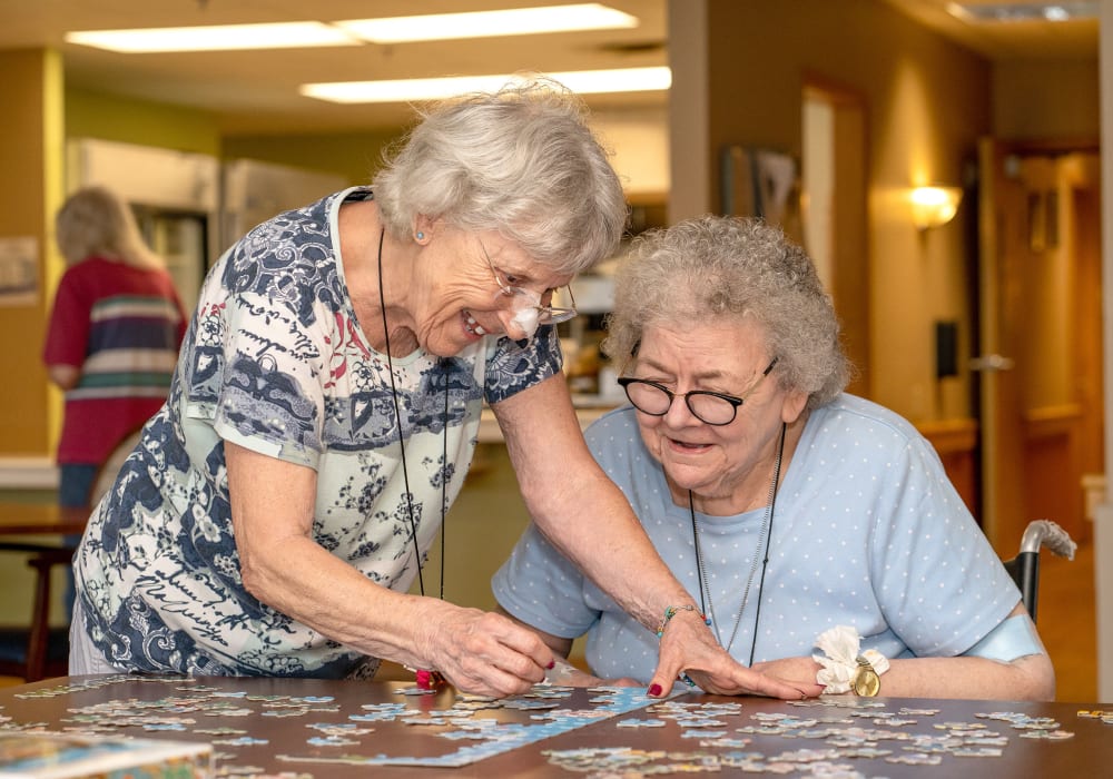 Residents solving a jigsaw puzzle at Wellington Place at Rib Mountain in Wausau, Wisconsin