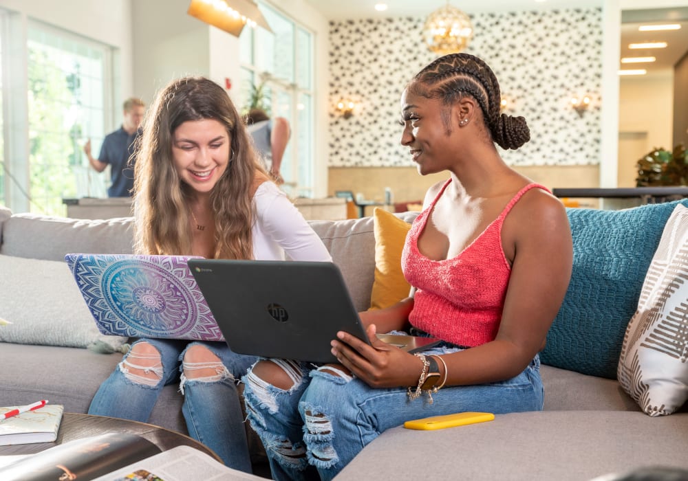 Residents using laptops at Ivy Row at South in Mobile, Alabama