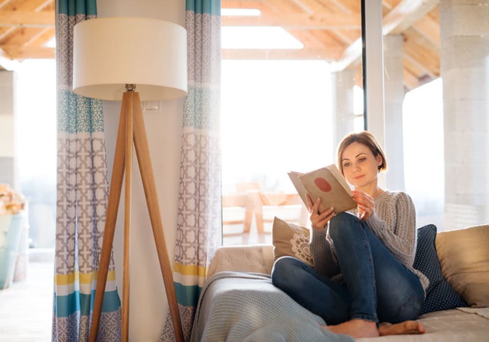 Resident reading in their apartment at Avery at Moorpark in Moorpark, California