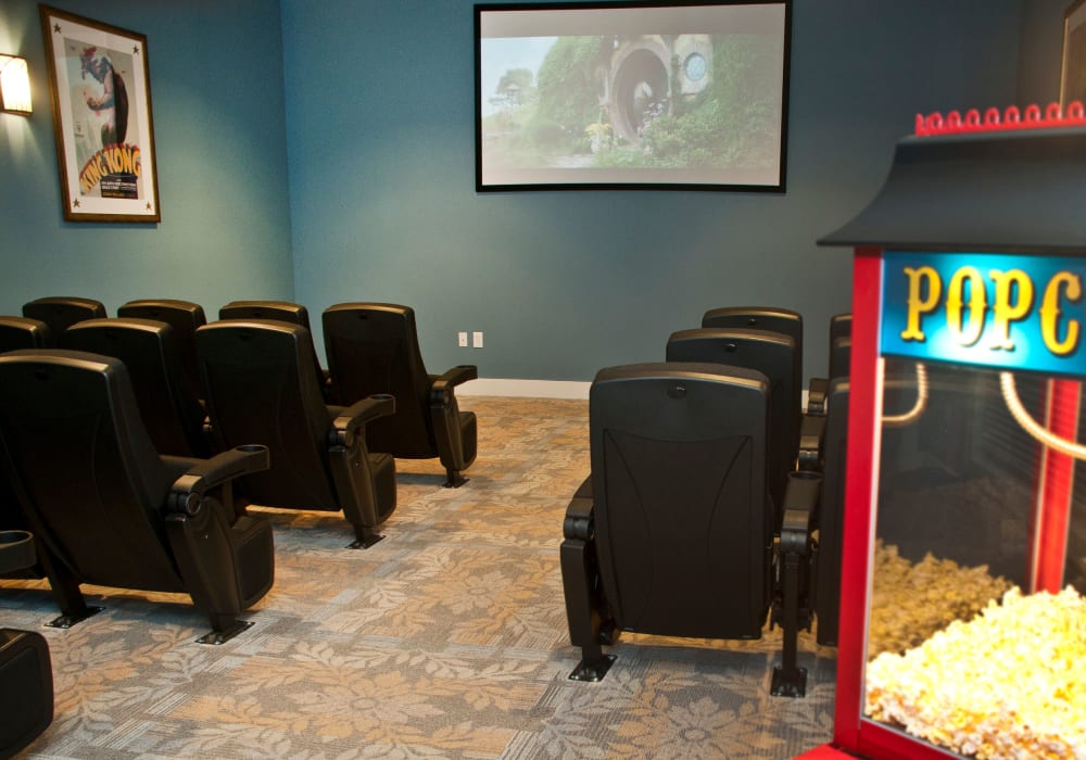 Seating and a popcorn machine in the community theater at Mariposa at Bay Colony in Dickinson, Texas