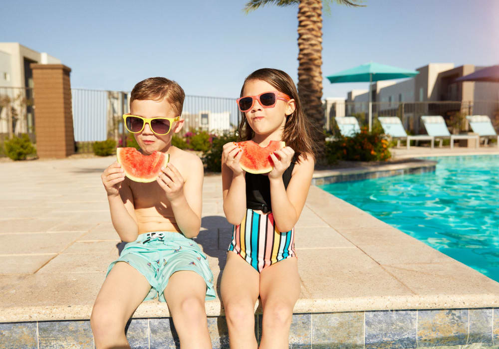 Kids eating watermelon after finishing swimming at BB Living at Val Vista in Gilbert, Arizona