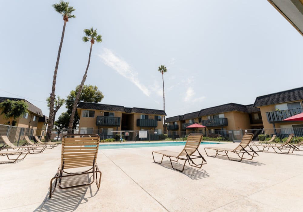 Poolside seating at Casa La Palma Apartment Homes in La Palma, California