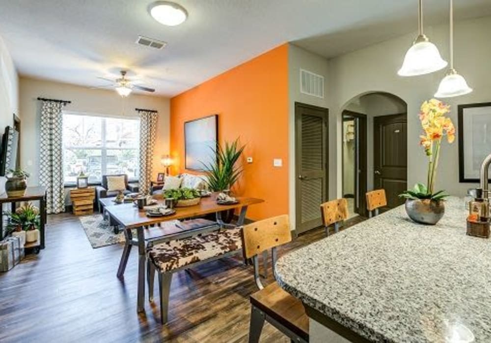 Apartment kitchen with granite counters and dining space at Addison at Tampa Oaks in Temple Terrace, Florida