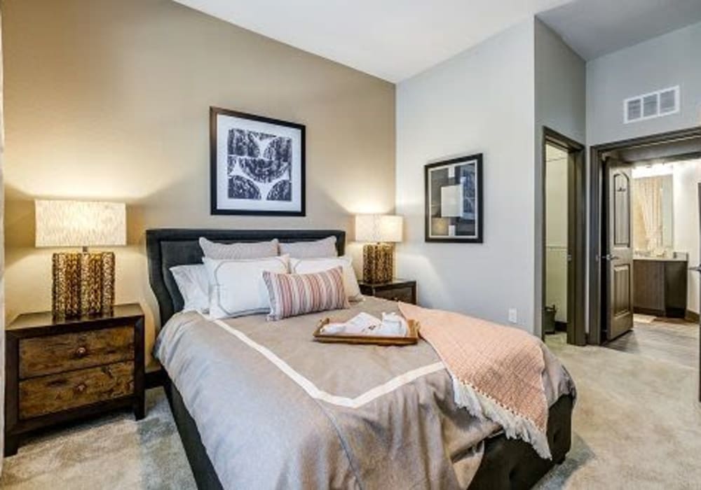 Cozy bedroom with multiple throw pillows at Addison at Tampa Oaks in Temple Terrace, Florida