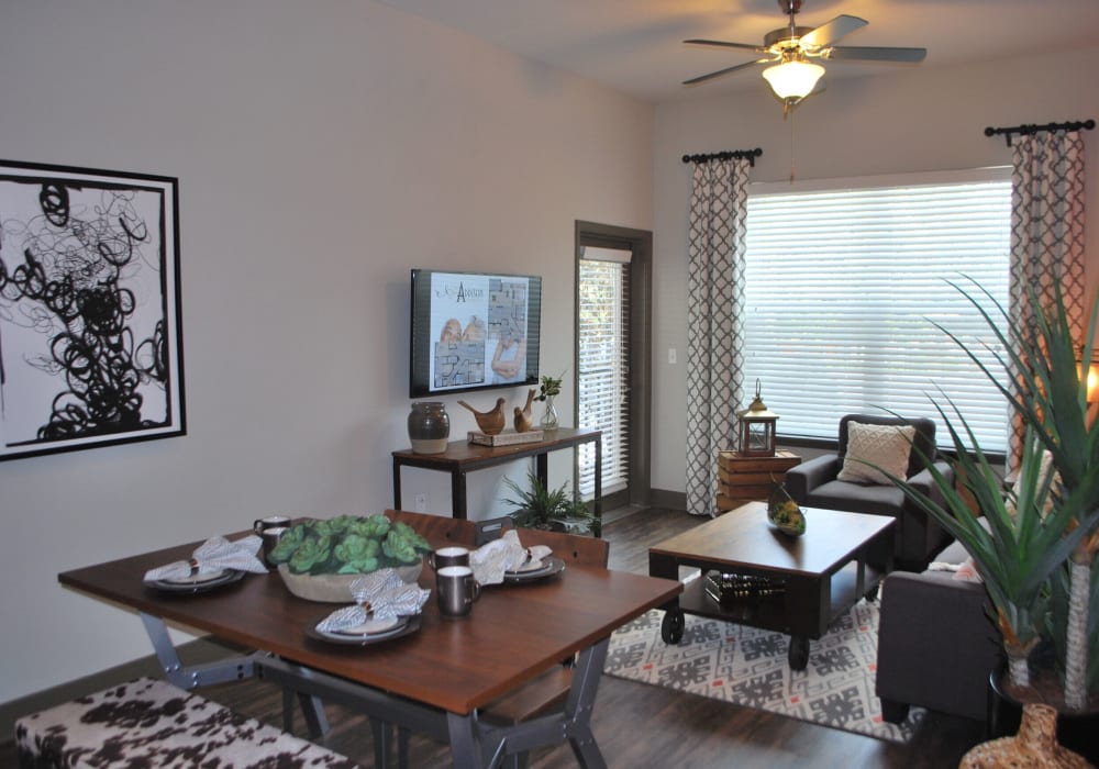 Apartment living room ceiling fan and hardwood floors at Addison at Tampa Oaks in Temple Terrace, Florida