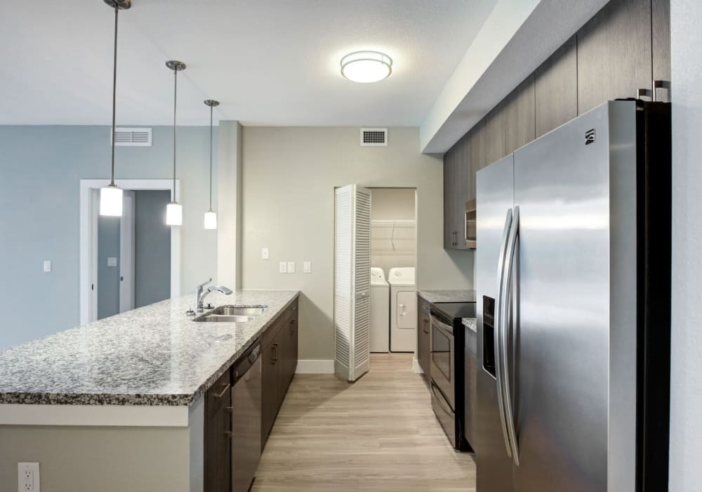 Apartment kitchen with stainless-steel fridge at Shalimar at Davie in Davie, Florida