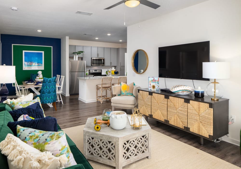 Living room with hardwood flooring and television at The Iris at Northpointe in Lutz, Florida