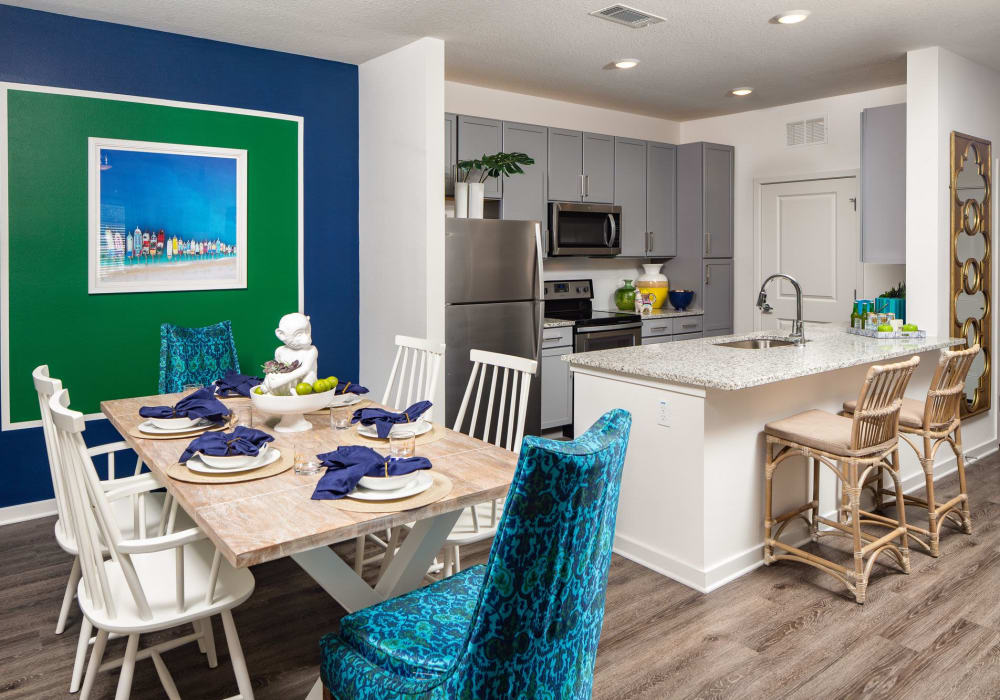 Apartment dining area with hardwood floors and modern table at The Iris at Northpointe in Lutz, Florida