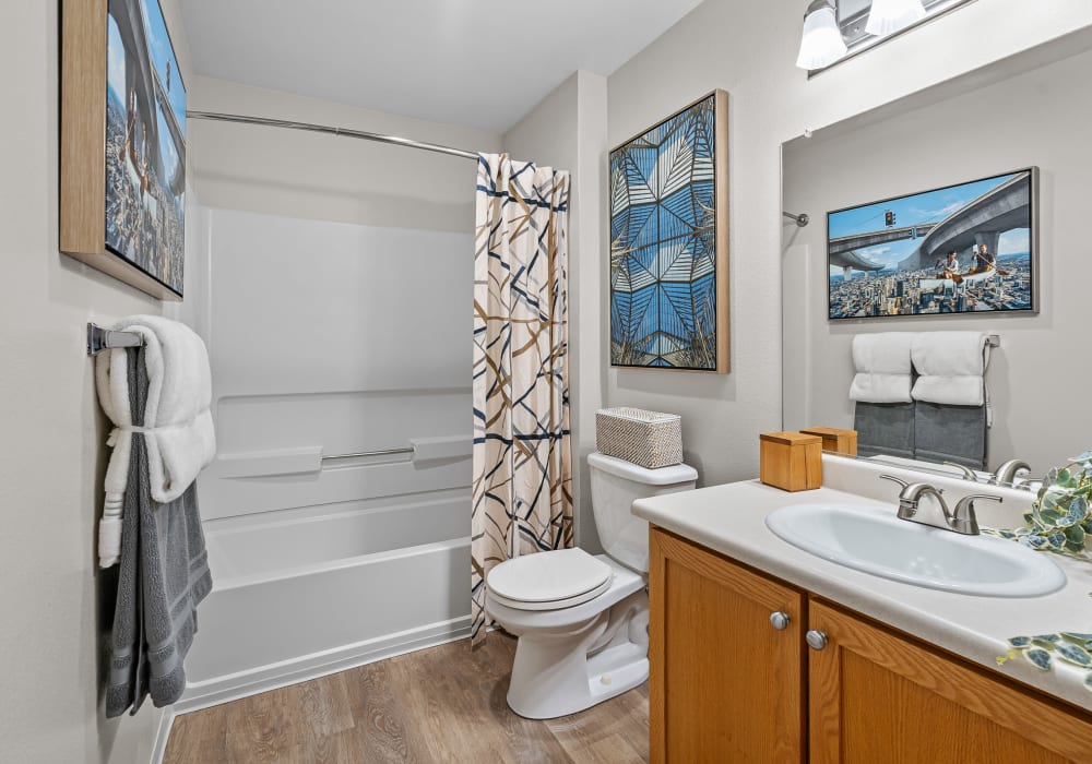 Model bathroom with wood-style flooring at Avery at Orenco Station in Hillsboro, Oregon
