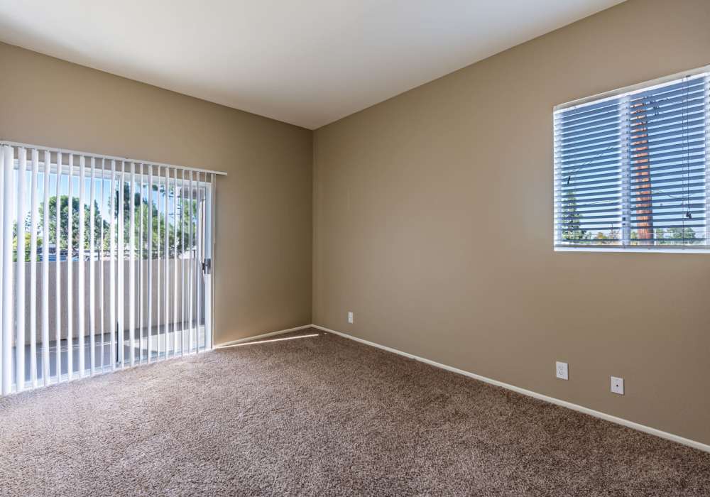 Bright bedroom with large windows at Seapointe Villas in Costa Mesa, California, 