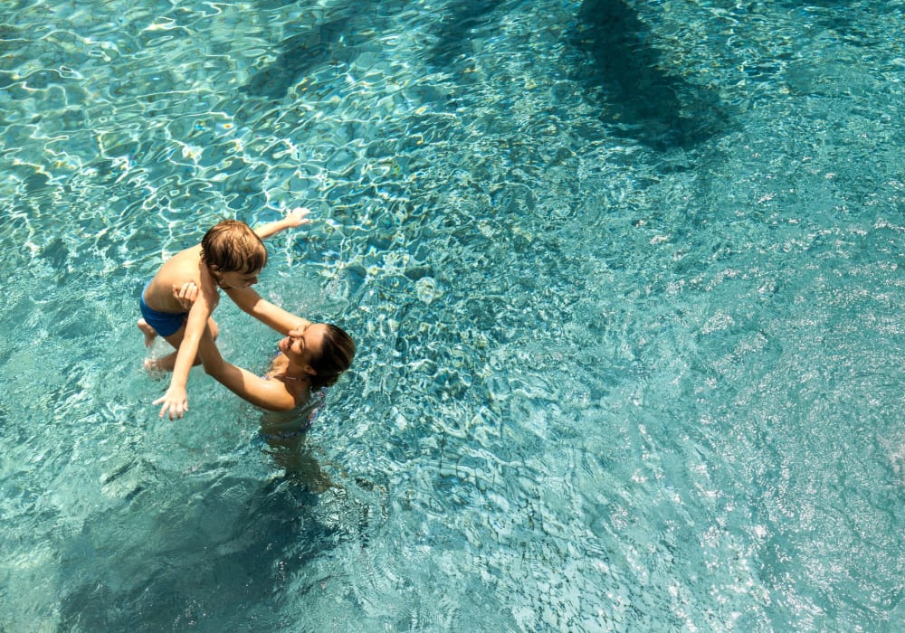 Mother with her kid in swimming pool at Eaton Ranch in Chico, California
