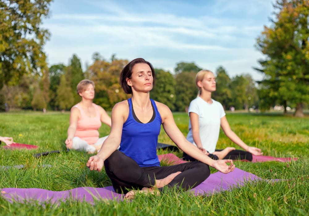 Residents doing yoga outside at Solera at Avalon Trails in Delray Beach, Florida