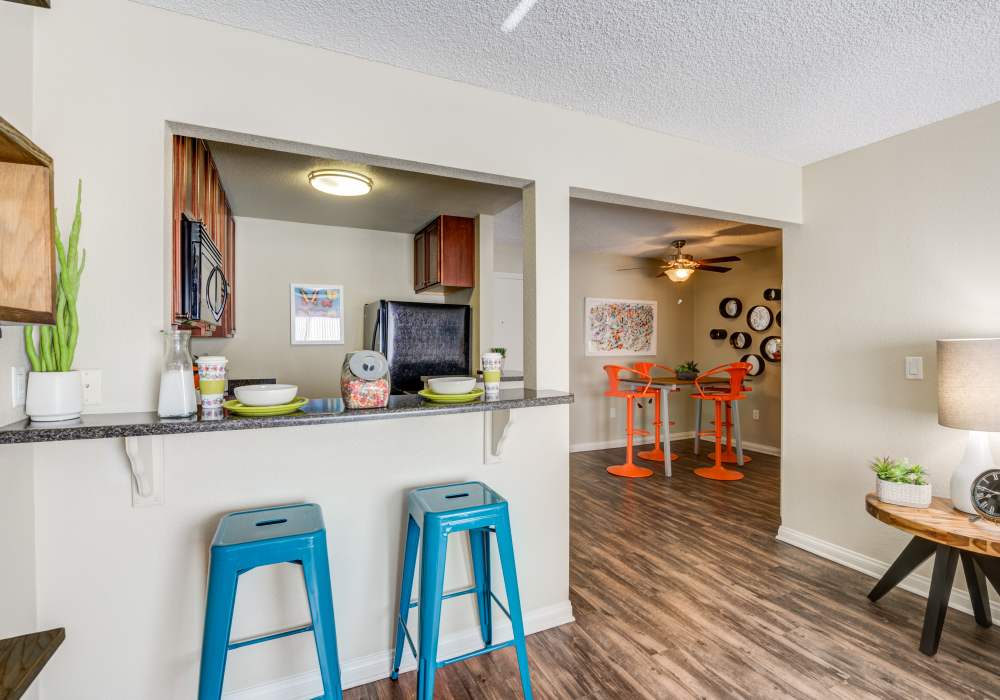Kitchen with breakfast counter at UCA Apartment Homes in Fullerton,California