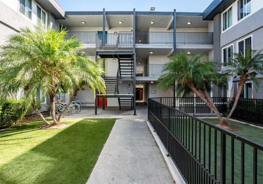 Property exterior with walkways at UCA Apartment Homes in Fullerton,California