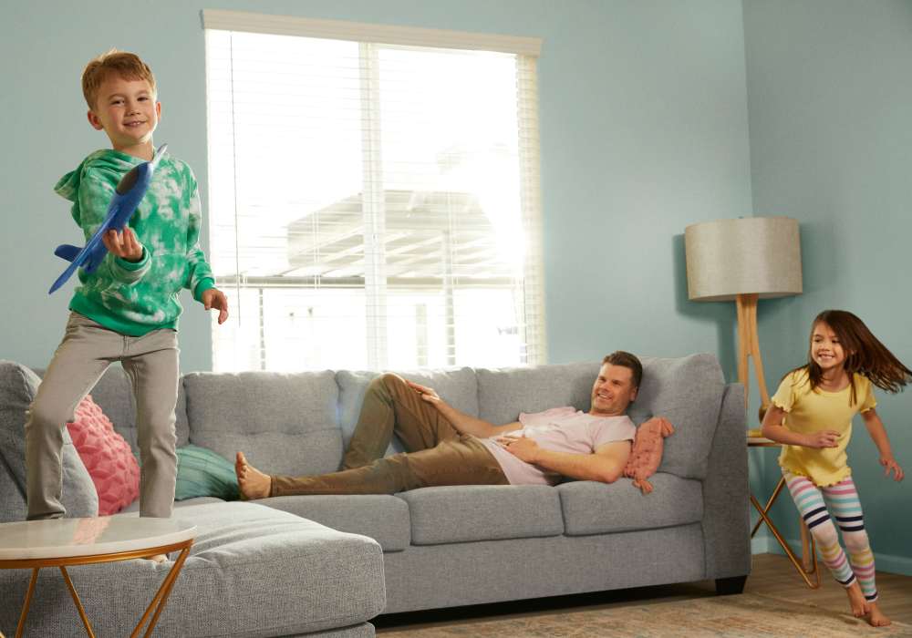 Dad and kids playing in the living room at BB Living Wellen Park in Venice, Florida